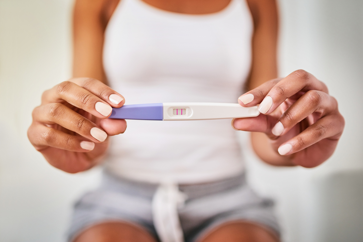 woman showing pregnancy test